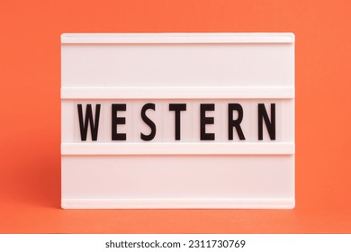 The word western on lightbox isolated orange background. Literary Genres - Shutterstock ID 2311730769