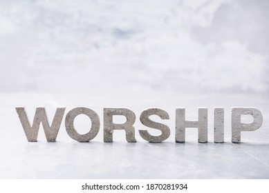 Word Worship made with cement letters on grey marble background. Copy space. Biblical, spiritual or christian reminder. Good friday, Easter day in church. Christian music concert, Sunday service.