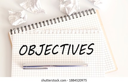 Word writing text OBJECTIVES . Business concept on the notebook