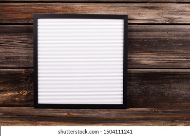 word written with white plastic letters on felt message board at rustic wooden wall, large copy space