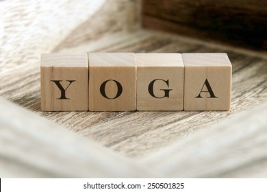 the word of YOGA on wooden cubes