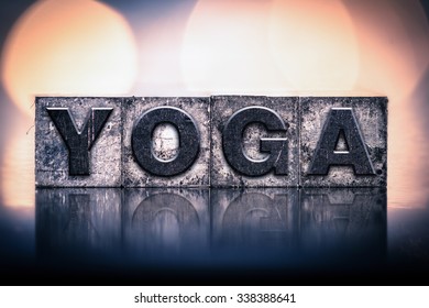 The word "YOGA" written in vintage ink stained letterpress type.