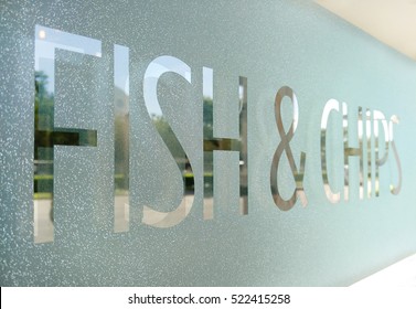 Wording "Fish & Chips" sticker put on clear glasses door or window