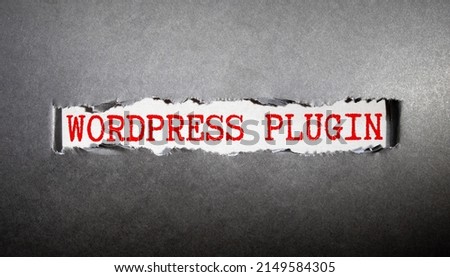 WORDPRESS text with decorative flower, keyboard, notepad and fountain pen on wooden background. Business and technology concept