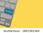WORDPRESS text on keyboard over yellow background. Business and technology concept
