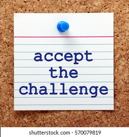 The words accept the challenge in blue text on a note card pinned to a cork notice board as a reminder to embrace change and opportunities