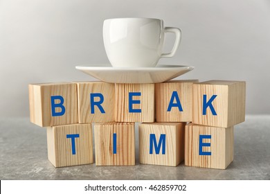 Words BREAK TIME And Cup Of Tea On Grey Background