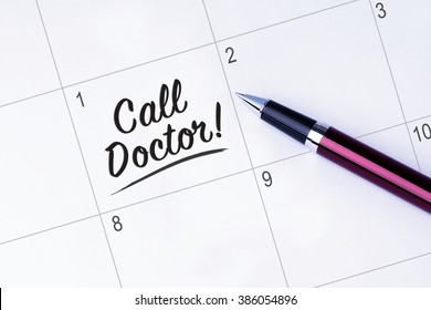 The Words Call Doctor Written On A Calendar Planner To Remind You An Important Appointment With A Pen On Isolated White Background. 