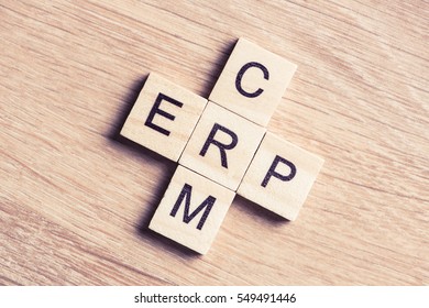 Words CRM and ERP collected in crossword with wooden cubes