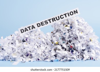 Words Data Destruction On Top Of Heap Of Cross Shredded Paper Concept On Blue Background