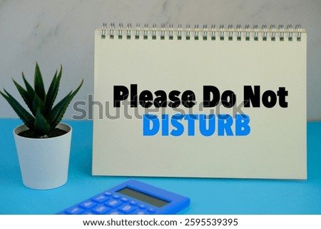 the words Do not disturb beside mini alarm clock on a plain background. the concept of me time and management concept.