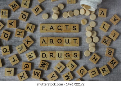 Words FACTS ABOUT DRUGS Written With Scrabble Letters And Surounded By Other Letters And Medicaments. Close Up Editorial Photo. Drug Abuse Concept. 