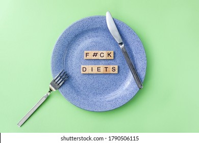 Words Fuck Diets. Wooden Blocks With Lettering On Empty Plate Surrounded By Knife And Fork. Intuitive Eating Concept.