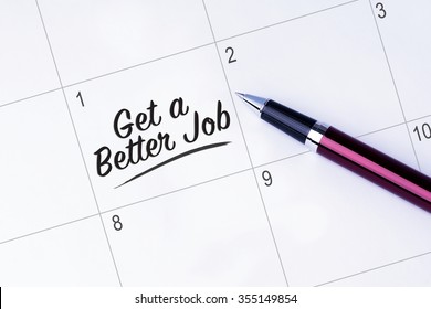 The Words Get A Better Job On A Calendar Planner To Remind You An Important Appointment With A Pen On Isolated White Background. New Year Concepts Of Goal And Objective.