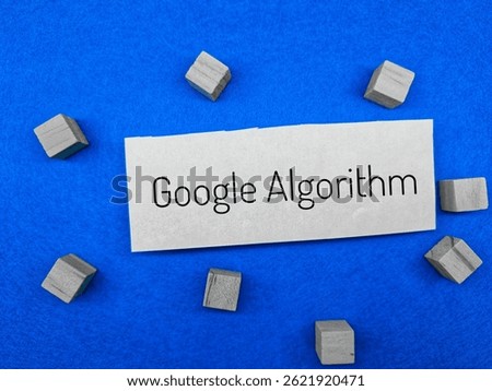 Words Google Algorithm on white paper with scattered wooden blocks on vibrant blue background, concept for SEO, search engine, online marketing and digital strategy. 