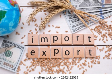 Words Import and Export made of cubes, ears of wheat, banknotes with globe on white wooden table, flat lay