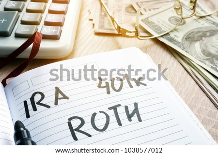 Words IRA 401k ROTH handwritten in a note. Retirement plans.