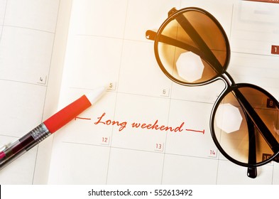 The Words Long Weekend Written On A Calendar Page To Remind.