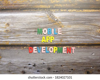 Words Mobile app development on wood background
