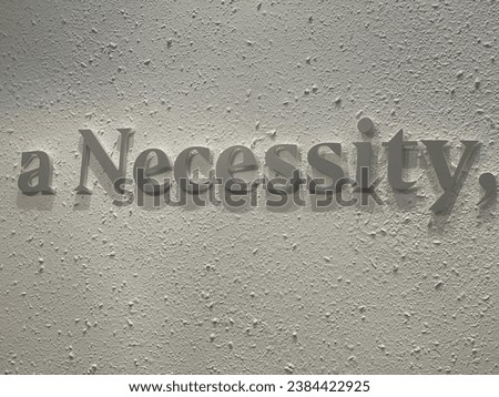 the words a necessity on the wall [[stock_photo]] © 