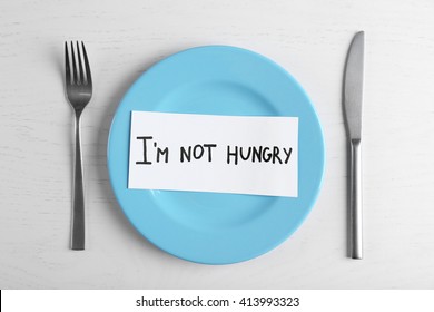 Words I'm Not Hungry In A Plate On White Table. Top View.