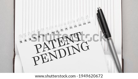 Words Patent Pending text on notepad and pen