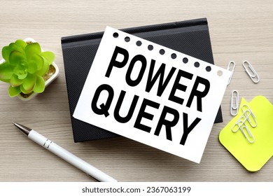 the words Power Query. on a white page on a black notepad - Shutterstock ID 2367063199