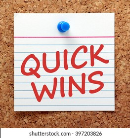 The Words Quick Wins In Red Text On A Card Pinned To A Cork Notice Board As A Reminder