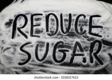 Words Reduce Sugar Written In And With Sugar Grains, Capital Letter, Sugar Health Concern Concept