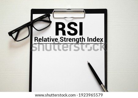 Words Relative Strength Index - RSI written on a book. Business concept.