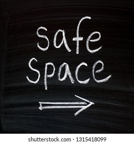 The Words Safe Space Written By Hand In White Chalk On A Blackboard