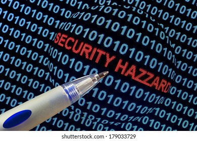 The words "security hazard" in red binary code on computer monitor.