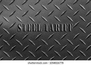 Words steel tariff written on textured steel sheet with diamond plate pattern/USA steel tariff dispute concept