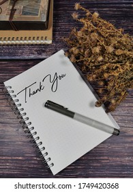 Words Thank You On Spiral Note Book Over Wooden Background. Message Appreciation Concept.  