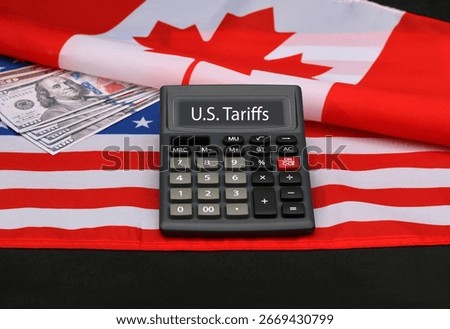 Words U.S. Tariffs on the display of a calculator with Canada and US flag.