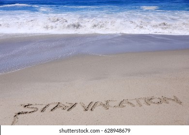 Words Vacation And Staycation Or Stay Vacation Written In Sand On The Beach With Ocean Tide And Waves