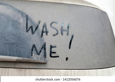 The Words Wash Me Written On A Dirty Car Rear Window, Outdoor Close-up