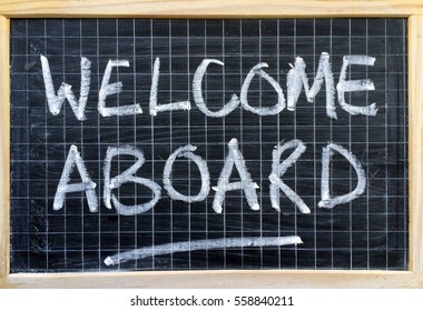 The Words Welcome Aboard Written By Hand On A Blackboard As An Invitation Or Message To A New Employee Or Partner