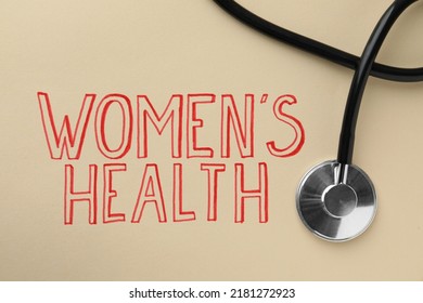 Words Women's Health And Stethoscope On Beige Background, Top View