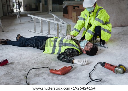 Work accidents of worker in the workplace at construction site area, Builder accident falls ladder on floor and Unconscious, Electric shock, Unsafe concept.