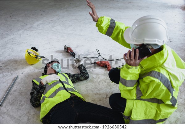 Work accidents of worker in workplace at\
construction site area and Unconscious with colleague motion and\
call to the safety officer for rescue and Life-saving. Selection\
focus on an Injured\
person.