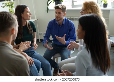 Work addict people talking on group therapy meeting, sitting in circle, discussing addiction, mental health problems. Counselor speaking, giving support and advice to team for successful recovery