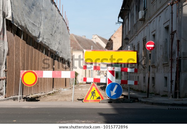 Work ahead street barricade barriers with caution\
traffic signs in the city