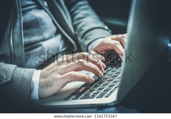 Work is always in my hands. Close up\
human hands. Business man working on laptop in\
car.