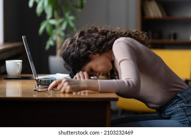 Work burnout. Tired exhausted female employee feeling energy depletion or exhaustion, overworked stressed female putting head down on table, suffering from chronic job stress. Overwork concept - Shutterstock ID 2103232469