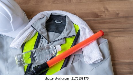 Work Clothes And Water.Workers To Prevent Heat Stroke.Red Stick And Security Guard Uniform.