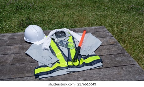 Work Clothes And Water.Workers To Prevent Heat Stroke.Red Stick And Security Guard Uniform.