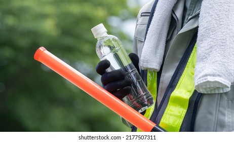 Work Clothes And Water.Workers To Prevent Heat Stroke.Red Stick And Security Guard Uniform.