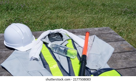 Work Clothes And Water.Workers To Prevent Heat Stroke.Red Stick And Security Guard Uniform.