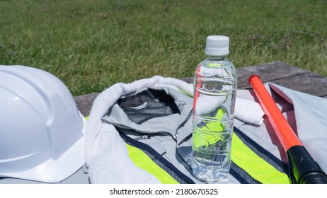 Work Clothes And Water.Workers To Prevent Heat Stroke.Red Stick And Security Guard Uniform.